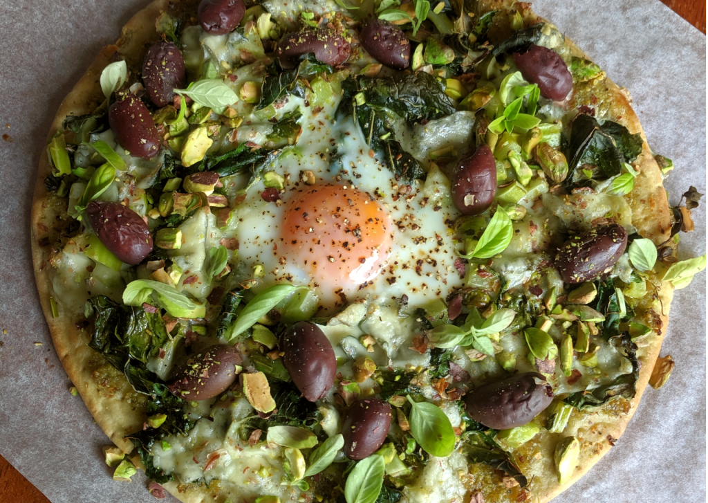 Cauliflower stem and leaf pizza with egg