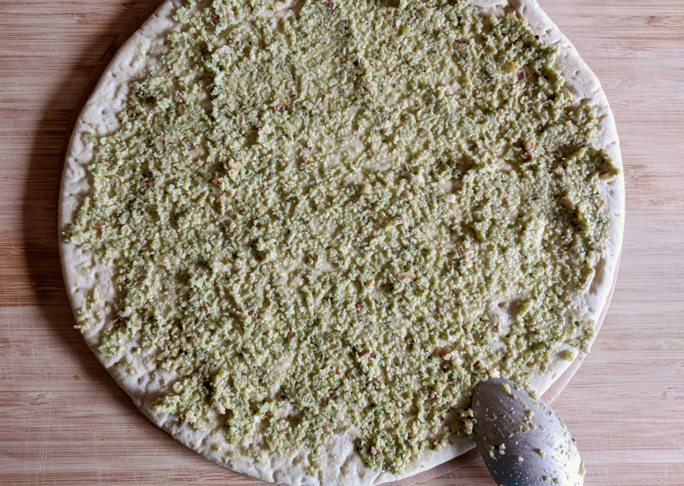 Kale stem oesto spread on a pizza base